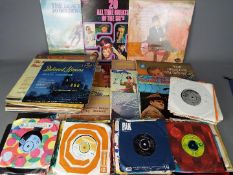 A collection of 7" and 12" vinyl records to include The Beach Boys, Deep Purple, The Beatles,