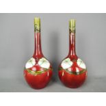 A pair of Minton Secessionist vases of slender necked, bottle form,