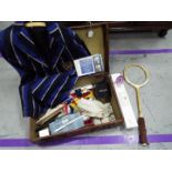 A vintage suitcase containing a mixed lot of collectables to include vintage tennis racket, flags,