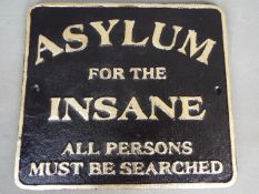 A cast sign marked Asylum