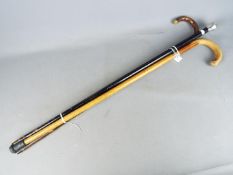 A walking stick with 9ct rose gold collar, a silver topped walking stick and one other.
