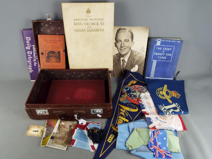 A vintage case containing a quantity of military and Royal related items.