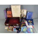 A vintage case containing a quantity of military and Royal related items.