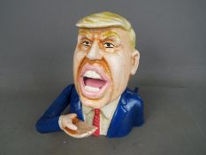 A cast money bank of Donald Trump.