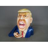 A cast money bank of Donald Trump.