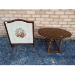 An Oak fire screen with an embroidered tapestry panel and glass front plus a small solid wood drop