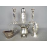 Silver - a pair of Silver hallmarked candle sticks, 14 cm (h) ( hallmarks unclear ) (one a/f),