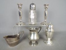 Silver - a pair of Silver hallmarked candle sticks, 14 cm (h) ( hallmarks unclear ) (one a/f),