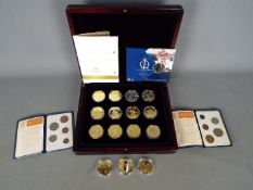 A case containing twelve gold plated commemorative crowns including Elizabeth II 80th birthday