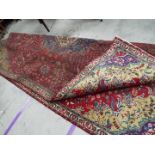 A polychrome Persian Tabarese carpet measuring approximately 328 cm x 232 cm