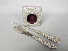 An Edward VII hallmarked silver front pocket watch travel case, repousse decoration,