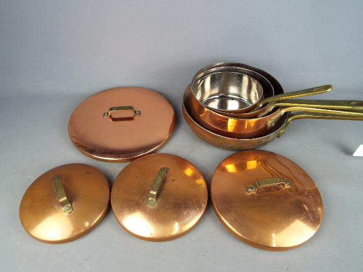 A set of four good quality copper cooking pans.