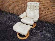 A swivel chair with matching footstool.