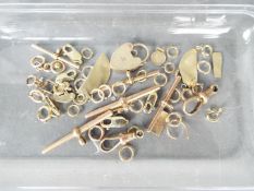 Scrap Gold - A quantity of scrap 9ct gold and yellow metal jewellers parts,