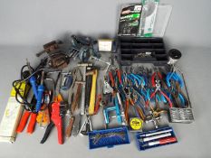 A collection of tools to include some watchmakers tools.