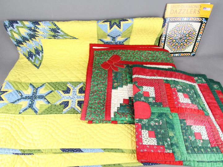 Three American style, patchwork quilts, largest 155 cm x 155 cm and related literature.