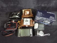 Photography - A collection of cameras to include a Braun Paxina, Hanimex, Panasonic,