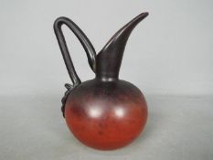 A Schneider glass ewer, dark red, etched signature, approximately 15.5 cm (h).