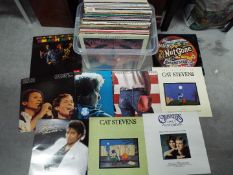 A collection of 12" vinyl records to include Cat Stevens, The Small Faces, Bruce Springsteen,