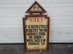 A large wooden sign purportedly used at Aintree racecourse reading 'Notice It Is Respectfully