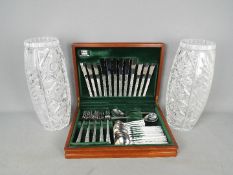 A six setting canteen of Viners Studio cutlery and a pair of large cut glass vases,
