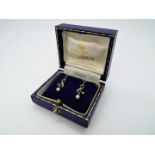 9ct Gold - a pair of 9ct gold stone set and pearl drop earrings, stamped,