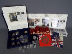 A coin case and contents with commemorative coins,