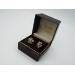 9 ct Gold - a pair of 9 ct gold earrings with a floral design, both with butterfly backs,
