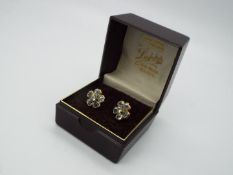 9 ct Gold - a pair of 9 ct gold earrings with a floral design, both with butterfly backs,