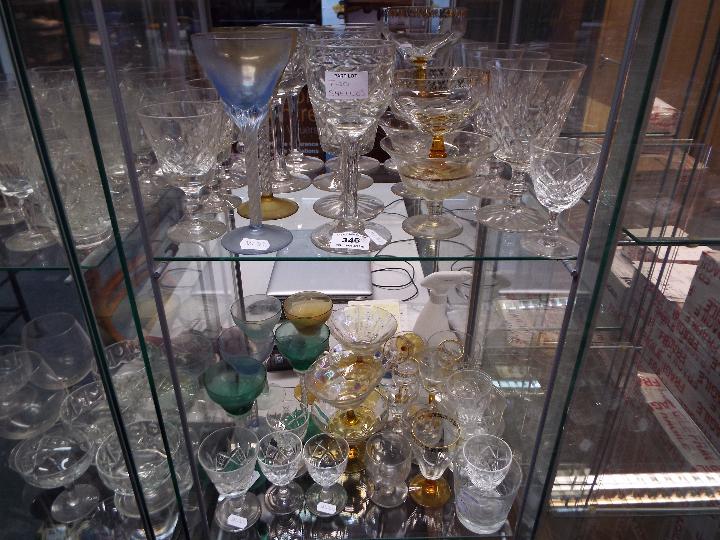 Glassware - a large quantity of drinking glasses with various design and sizes.