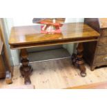 Victorian rectangular rosewood centre table raised on turned pillars to four bun feet, 75.