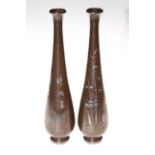 A pair of Japanese bronze vases inlaid with silver and gold bamboo, cockerels and inscriptions,