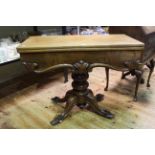 Victorian mahogany fold top tea table on turned pedestal to four scrolled legs.