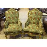 Pair ornate gilt framed armchairs with serpentine front seats in floral patterned fabric.