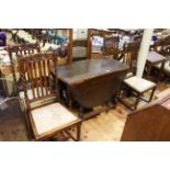 Oak barley twist drop leaf dining table with carved border and four barley twist dining chairs