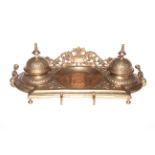 19th Century gilt metal desk stand with twin ink bottles, 18cm.