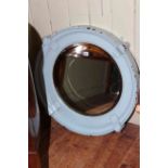 Porthole style bevelled wall mirror.