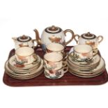 Twenty one piece Satsuma tea set with floral design.