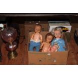 Oil lamps, skin bag, assorted records and various dolls.