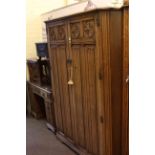 Carved oak linen fold panel double door wardrobe and dressing table.