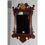 Regency style fretwork wall mirror with Phoenix crest, 65cm by 41.5cm.
