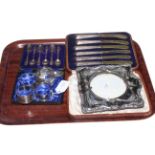 Silver photograph frame, cased silver spoons, silver handled knives and four silver napkin rings.