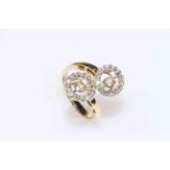 Gold set 'dancing' diamond ring, having two circles of centre stones with brilliant set borders.