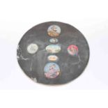 Seven Indian miniatures mounted on oval card.