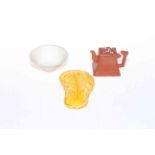 Chinese yellow glazed scroll weight, tiny red ware teapot and early small white bowl (3).