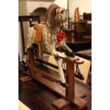Sponge painted rocking horse on safety stand, 100cm by 121cm.