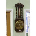 Oak twist column barometer with brass dial.