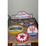 Seven cast metal advert signs including Goodyear, Esso, Maserati, etc.