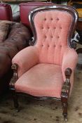 Victorian mahogany framed armchair in buttoned rose fabric.