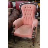 Victorian mahogany framed armchair in buttoned rose fabric.